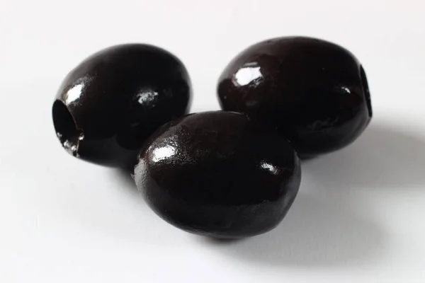 Three Black Olives Closeup — Stock Photo, Image