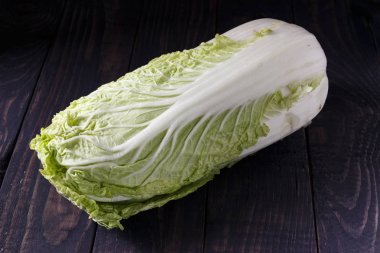 Green Peking cabbage on a wooden table clipart