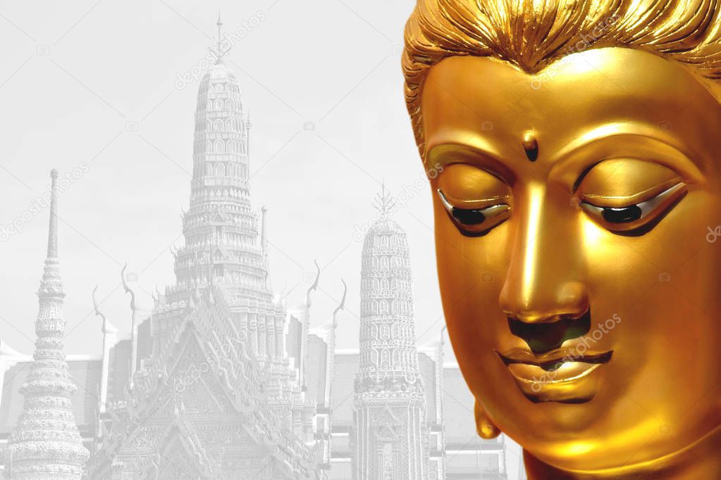 The golden face of the old Buddha statue with temple backdrop.