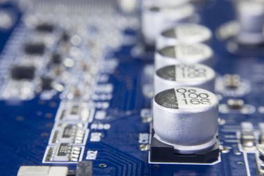 Close up macro of aluminum electrolytic capacitors installed on the motherboard clipart