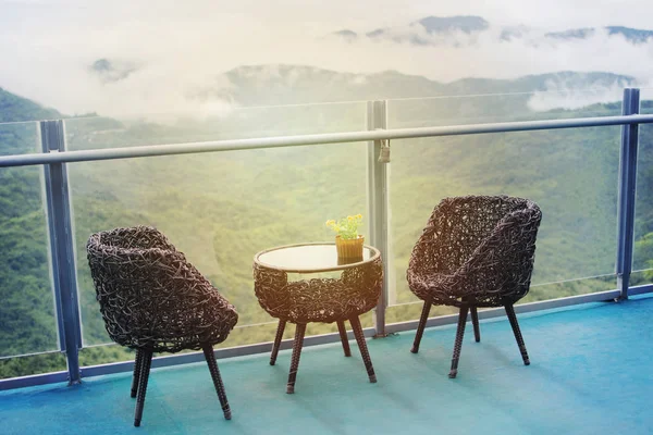 Rattan table and chairs set for relaxing and admiring misty valley views