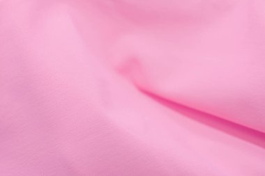 Kumaşın açık arkaplanı pembe ve bulanık arkaplan grafikler için mükemmel ve metin için boşluk.
