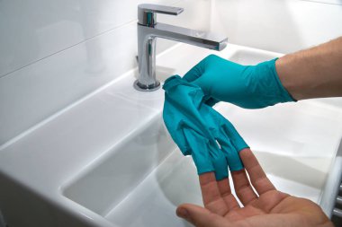 taking of medical gloves, close up clipart