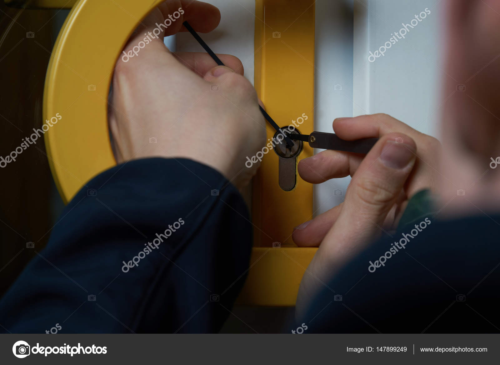 Burglar with lockpick tool opens the front door to enter the house ... Burglar with lockpick tool opens the front door to enter the house ...