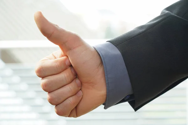 Businessman shows thumps up sign for his approval — Stock Photo, Image