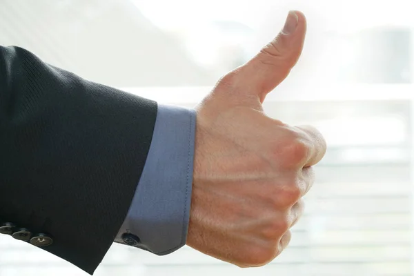 Businessman shows thumps up sign for his approval — Stock Photo, Image