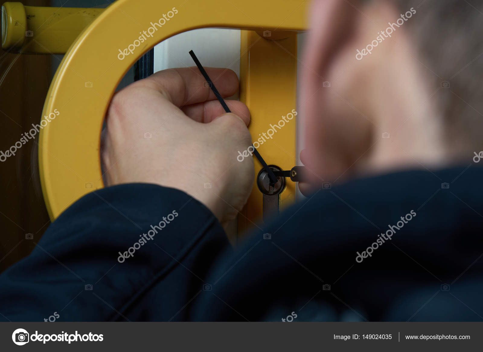 Burglar With Lockpick Tool Opens The Front Door To Enter The