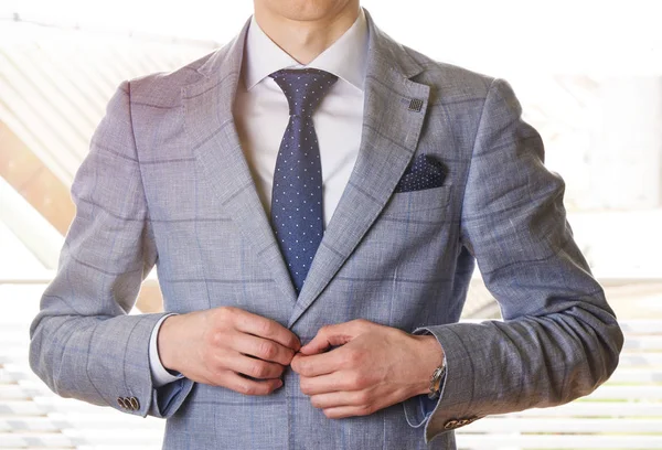 Unrecognizable businessman buttons his jacket up - in sunshine — Stock Photo, Image