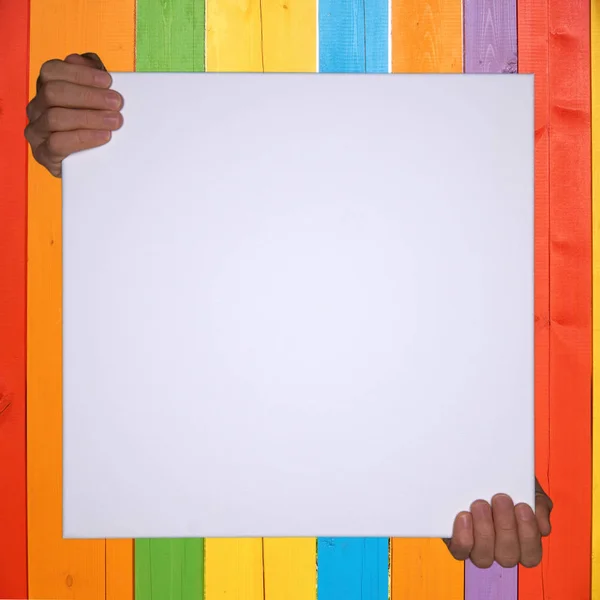 Isolated hands holding a empty canvas with colorful background and copyspace — Stock Photo, Image