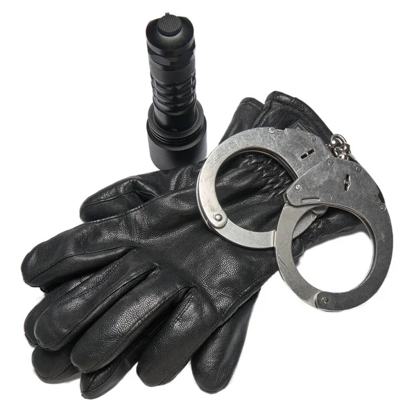 German police handcuffs, leather gloves and a torchlight isolated on white background. — Stock Photo, Image