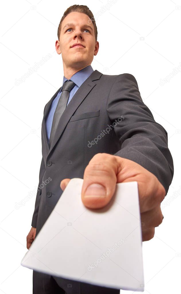 Isolated young attractive successful smiling businessman hands over a business card. Low angle shot with copy space.