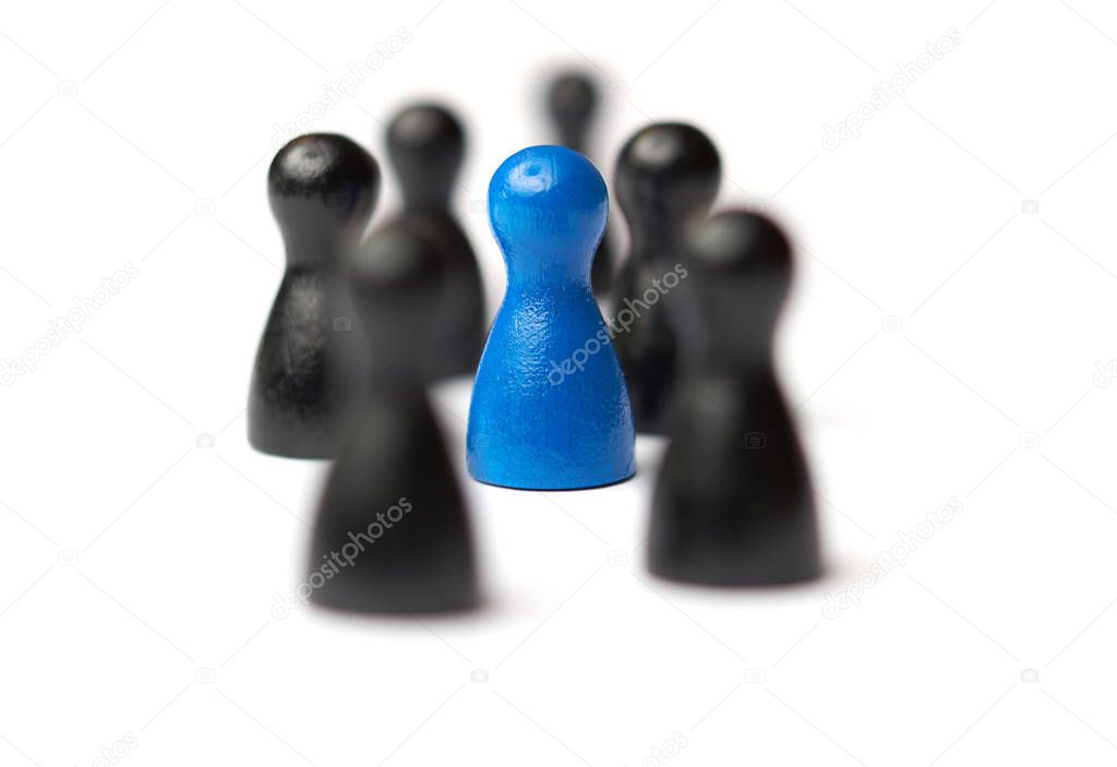 Blue figure in the middle of a group. Other figures blurred. Business concept for leadership, teamwork or groups. Isolated on white background.