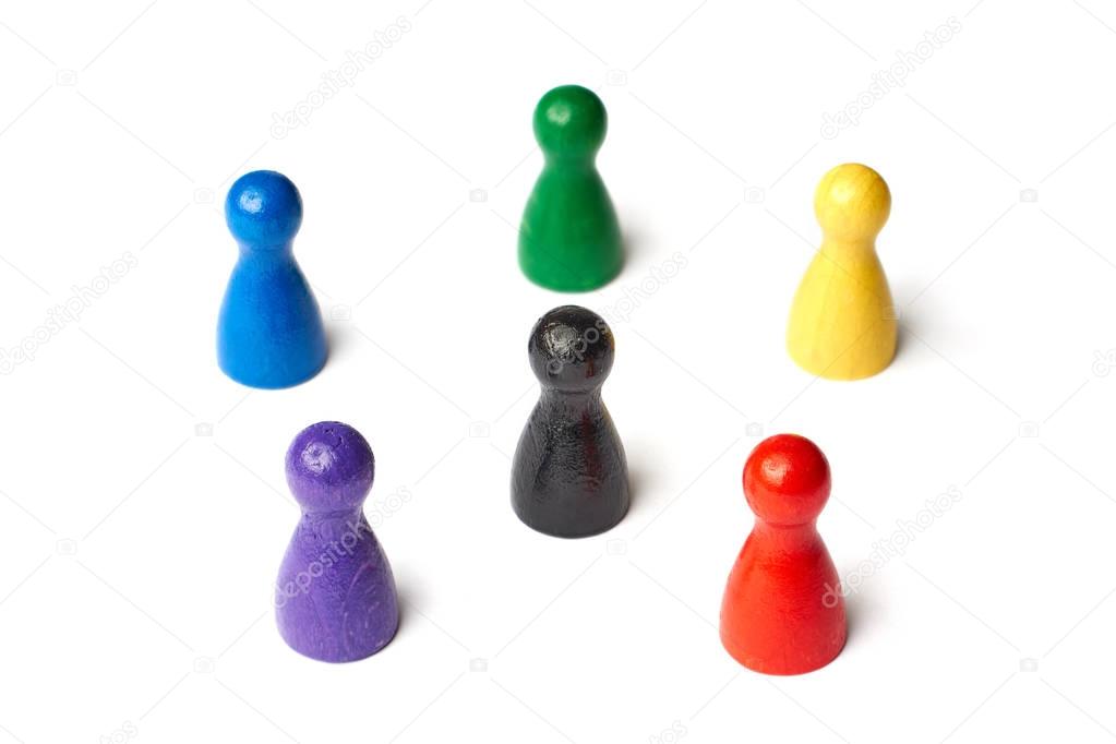 Six game figures standing in a circle with a black figure in the middle. Symbol for a color wheel or a group of people or teamwork.