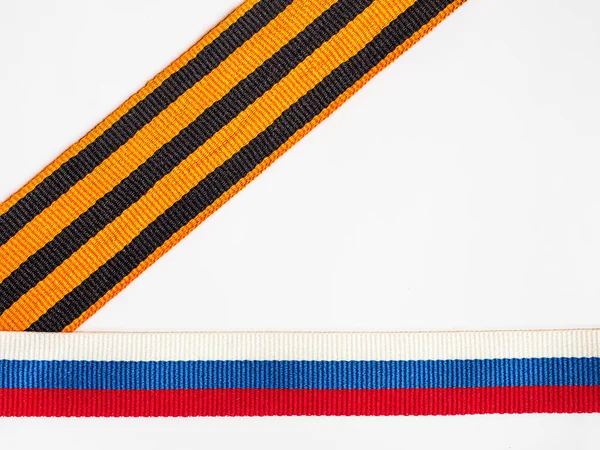 Tricolor blue white red ribbon and St. George ribbon on white background