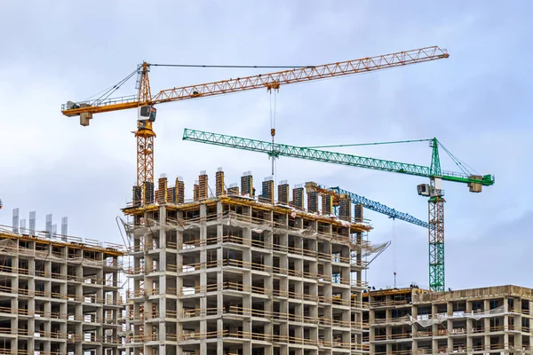 Construction of the third stage of a new residential complex \'in the forest\'. Work construction cranes, is the construction of walls of buildings. Moscow, Russia