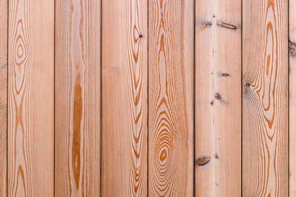 Background of wooden pine boards with a vertical arrangement, close up