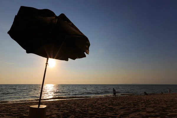 Palm beach umbrella on the beach during sunset — Stock Photo, Image