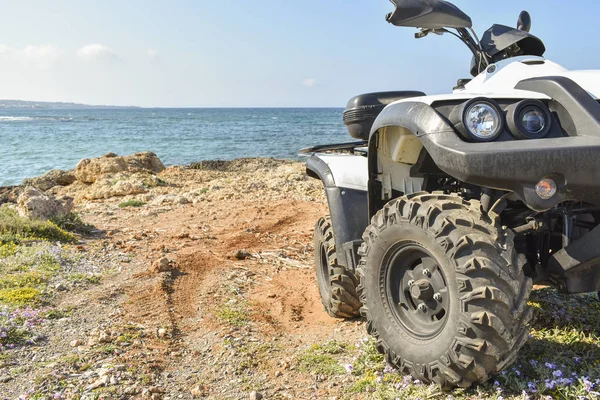 ATV offroad on sea and sky background