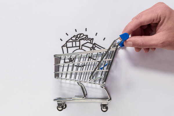 A hand is moving a minimal shopping cart.