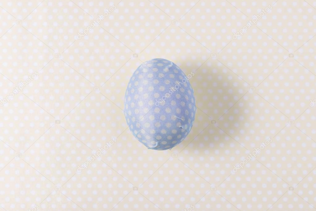 Easter egg decorated with blue paper napkin. Minimal concept.