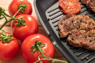 Domates ve baharat yakın çekim ile ızgara tava üzerinde ızgara biftek