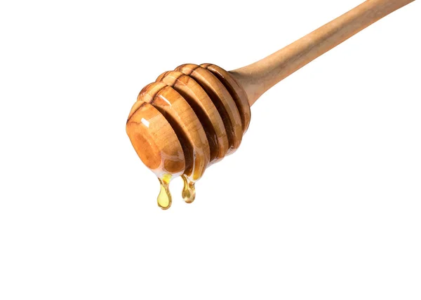 Honey dripping from honey dipper on white background. — Stock Photo, Image