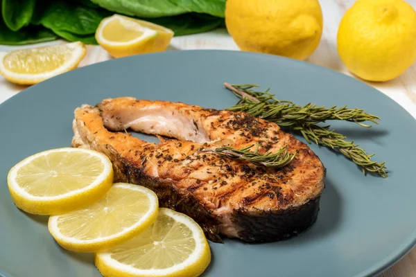 Salmon fillet. Grilled salmon with herb and lemon on plate.