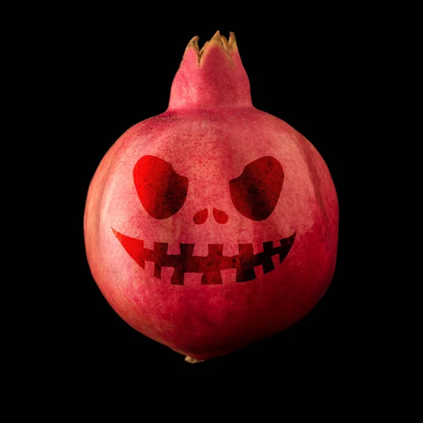 Halloween mask on a pomegranate — Stock Photo, Image