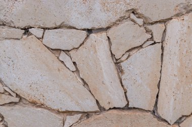 Bej taştan duvar dokusu arkaplanı.