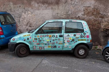 Roma, İtalya. 05 Aralık 2017: Sokakta mavi bir araba araba çıkartmaları kapak.