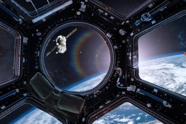 View from a porthole of space station on the Earth background. Elements of this image furnished by NASA. clipart