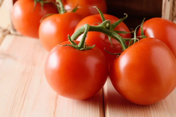 Close-up of fresh, ripe tomatoes on wooden background. — Stock Photo, Image