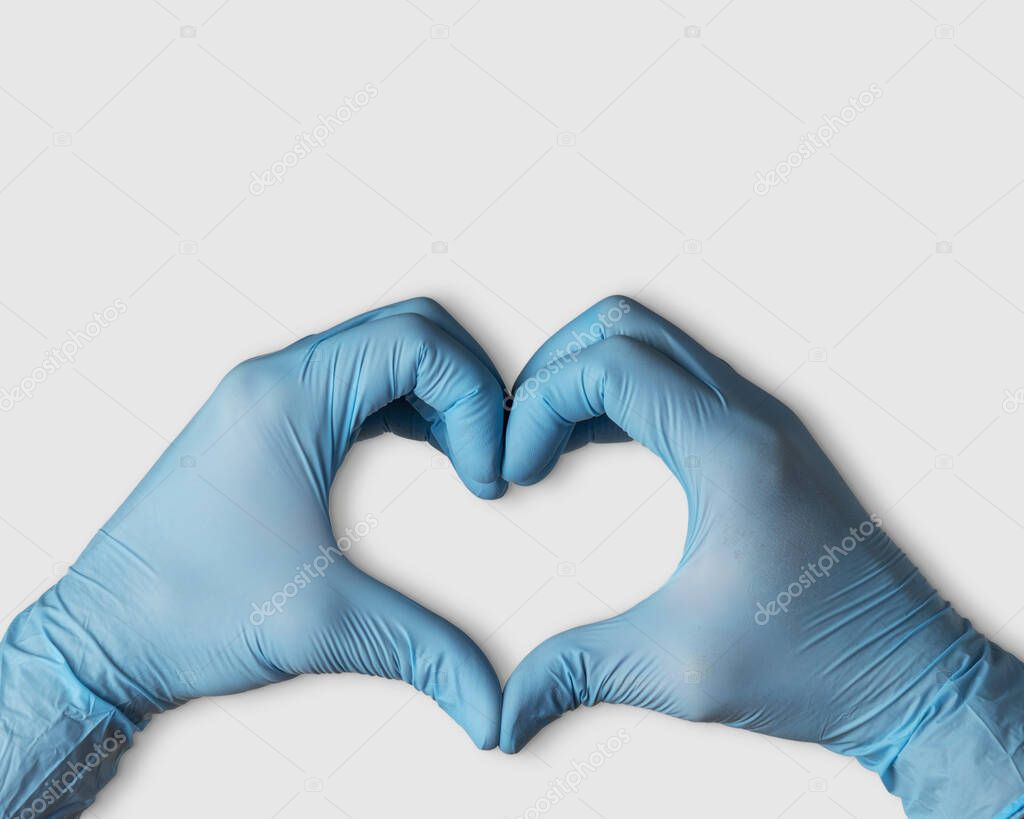 Hands in medical gloves in shape of heart on white background with copy space. Coronavirus prevention concept.