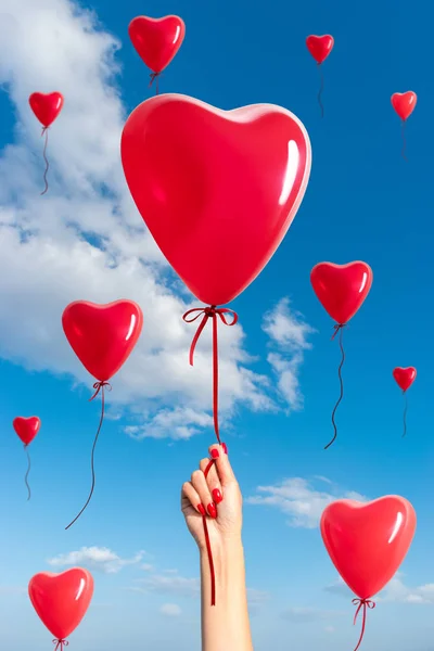 Womans Hand With Heart Shaped Balloon On Background Of Sky Love Concept Old Celebration Stock Photo