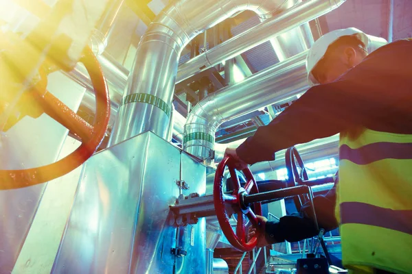 Industrial factory worker turning red wheel of valve — Stock Photo, Image