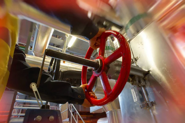 Obrero industrial girando rueda roja de la válvula — Foto de Stock