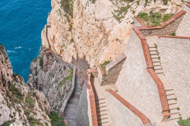 The rocky peninsula of Capo Caccia, with high cliffs, is located near Alghero; in this area there are the famous Neptune's Caves clipart
