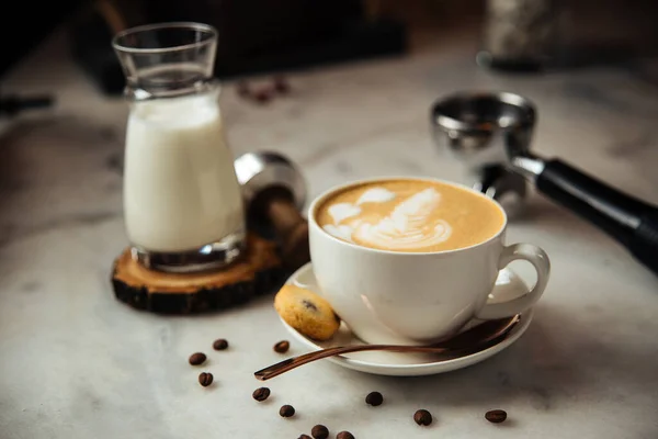 Кава капучино на сніданок з молоком та печивом на білому мармуровому столі — стокове фото