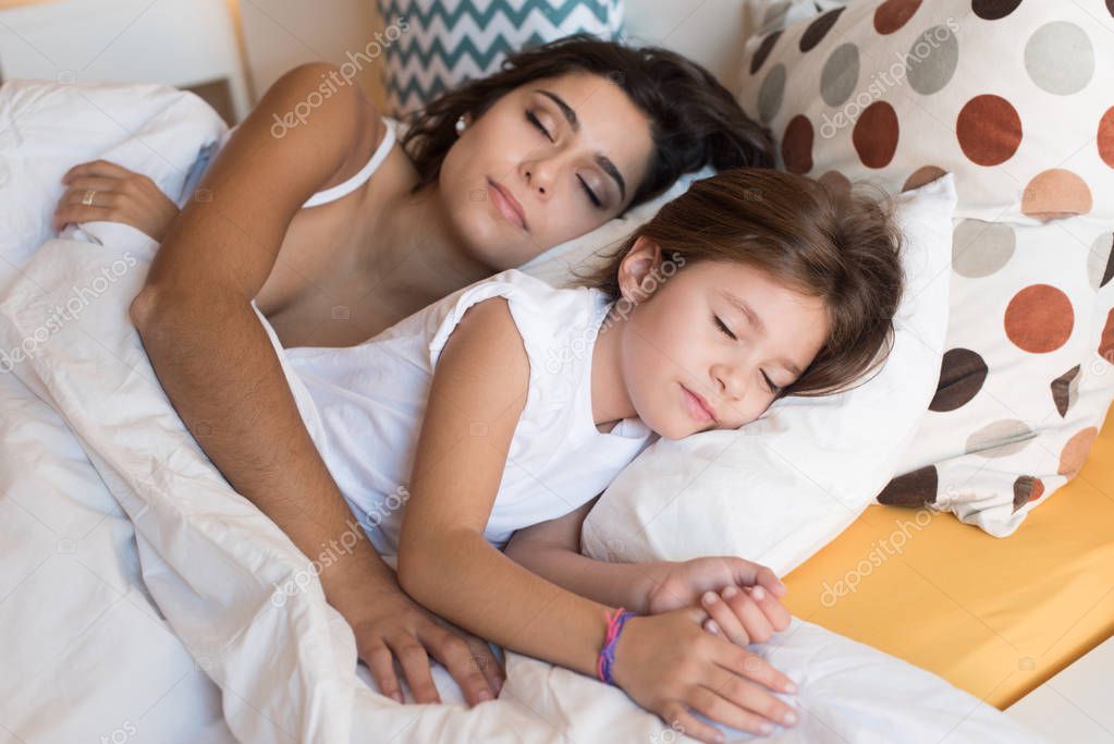 Mother and daughter in bed