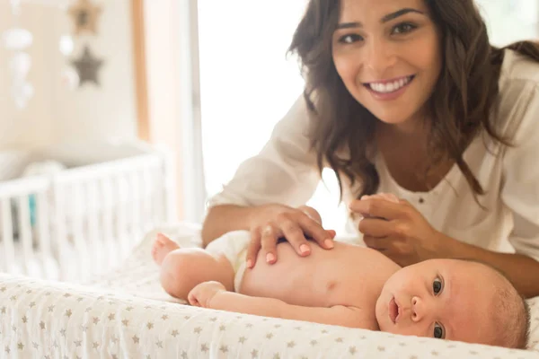 Mother moisturizing baby — Stock Photo, Image