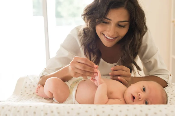 Mother moisturizing baby — Stock Photo, Image