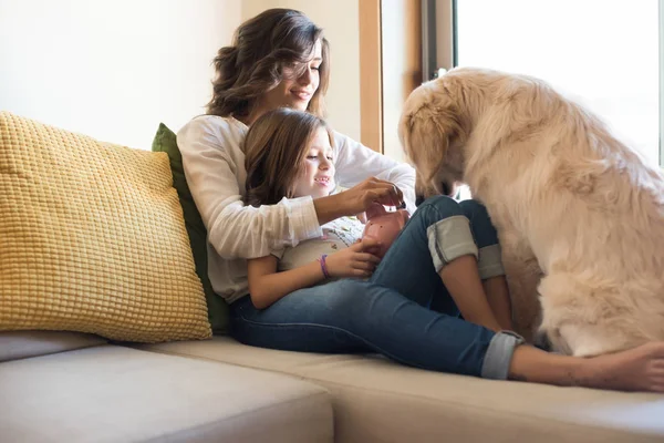 Dog with human family at home — Stock Photo, Image