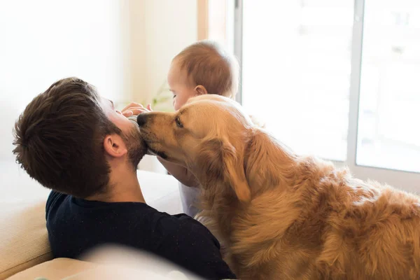 Family having fun with a feeding bottle — Stock Photo, Image