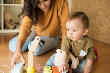 Anne bebeğiyle oynuyor.