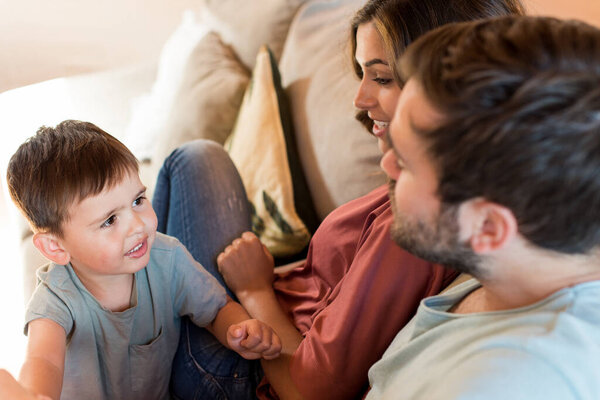 Family playing at home. Happy couple and little boy 