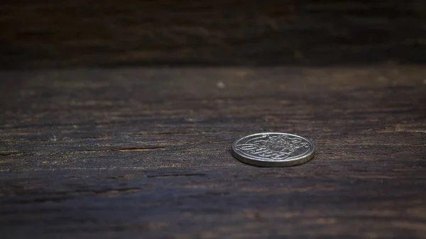 Concept with silver coins on old wooden floors