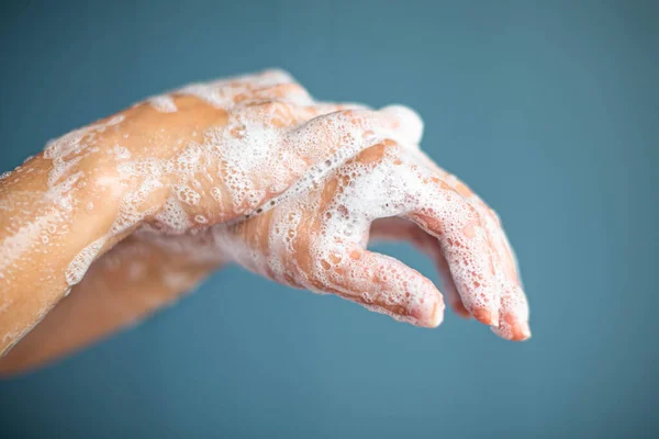 Closeup Hands Being Washed Suds Isolated Blue Background — Stock Photo, Image