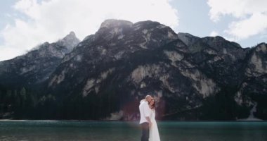 Romantik Çift mutlu birbirlerine sarılarak, arka plan büyük bir dağ. ağır çekim