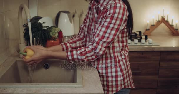 Young couple together washing the vegetables closeup then they go to prepare the food. — Stock Video