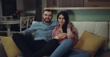 Genç tv izlerken birlikte çift ve gülümsüyorsun. Kırmızı epik